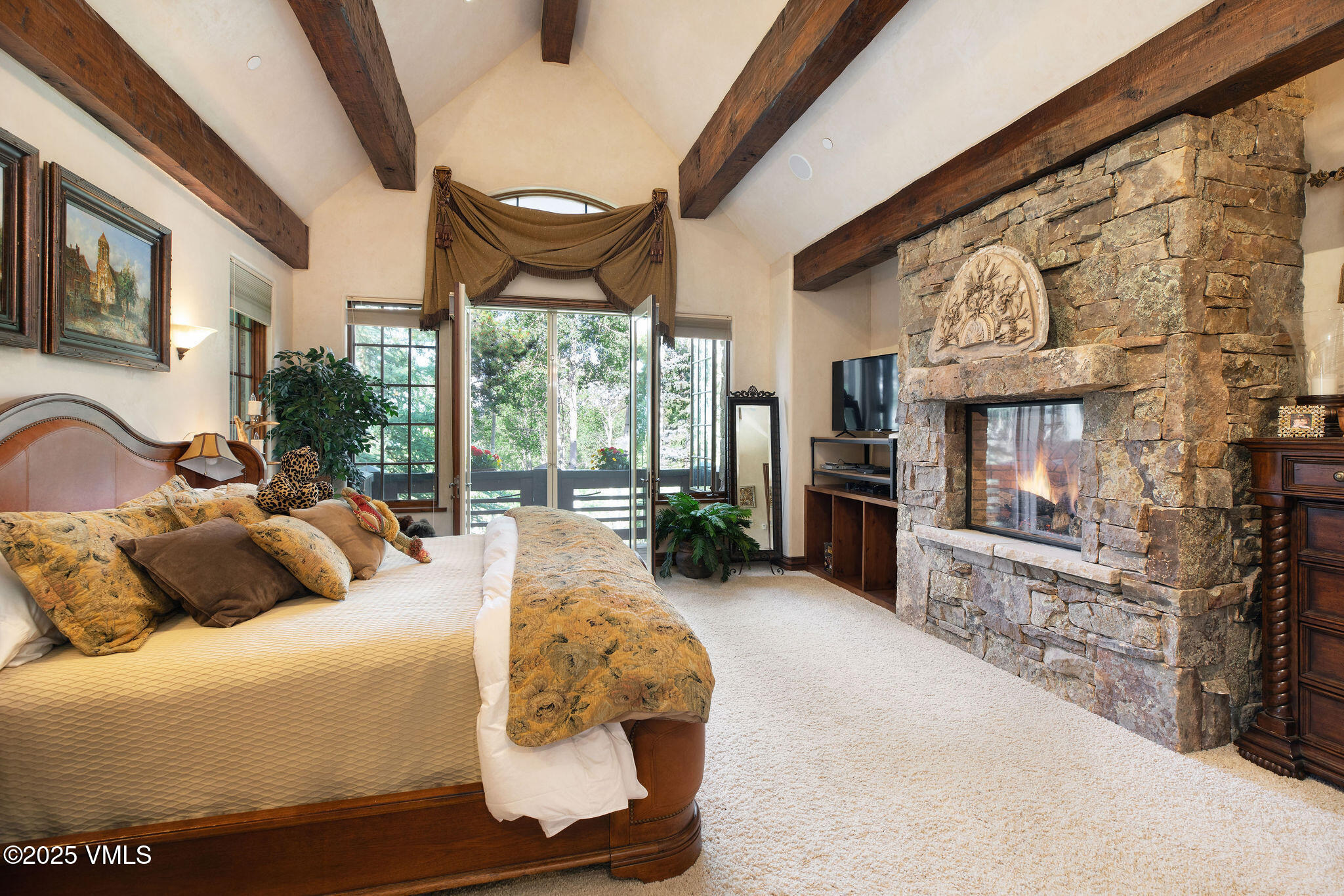 140 Elk Woods Road Edwards, CO 81632 - Photo 16 of 46 a bedroom with furniture and large windows