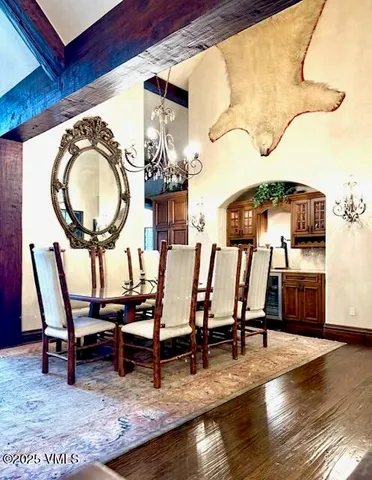 a living room filled with lots of furniture and a floor to ceiling window