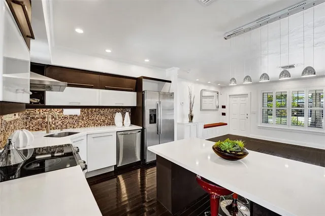 a kitchen with a sink a stove and a refrigerator