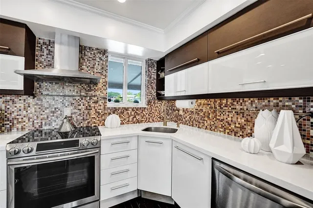 a kitchen with stainless steel appliances white cabinets and a wooden floor