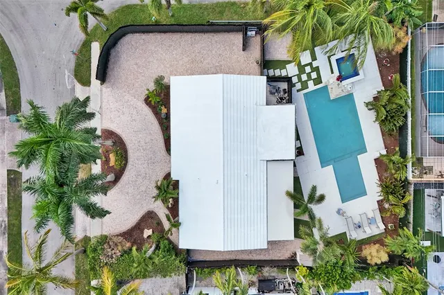 an aerial view of a house with outdoor space and seating area