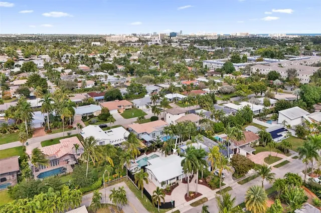 an aerial view of residential houses with city view