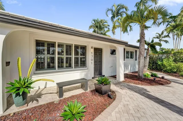 a potted plant sitting in front of a house
