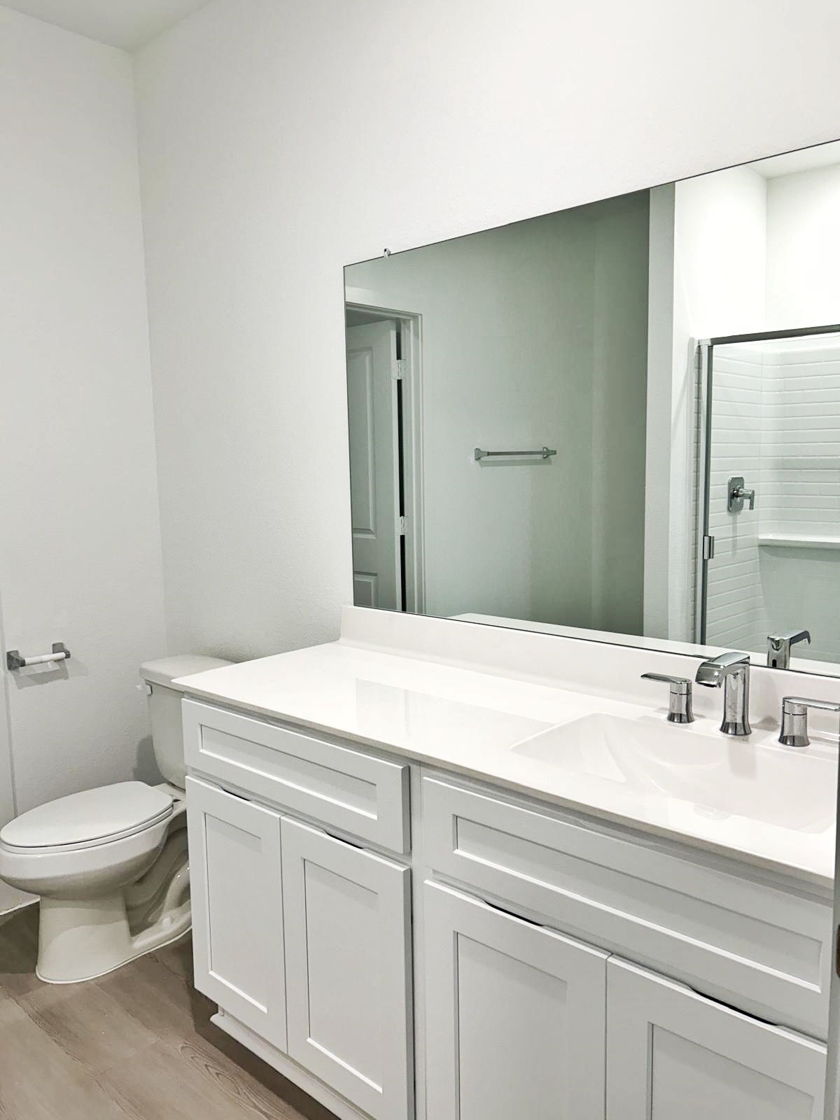 14973 Rustic Moon Road Conroe, TX 77302 - Photo 13 of 22 a bathroom with a sink a toilet and a mirror
