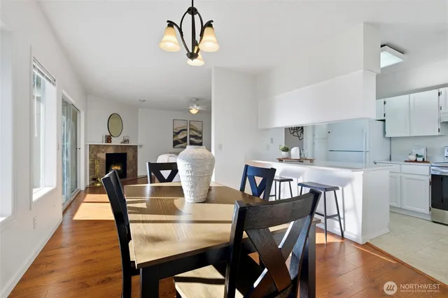 a view of a dining room with furniture wooden floor and chandelier