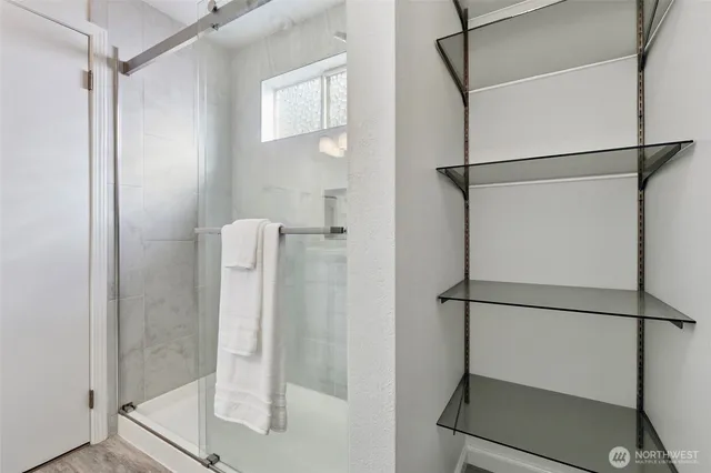 a bathroom with a glass shower door