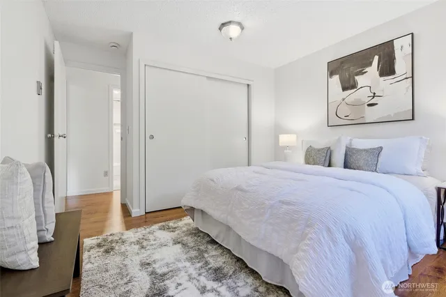 a bedroom with a bed and a painting on the wall