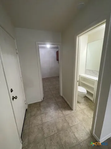 a view of a room with wooden floor and a toilet