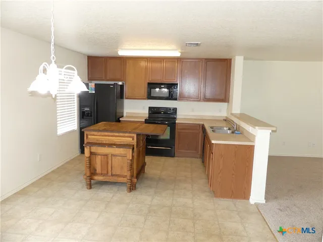 a kitchen with cabinets and appliances