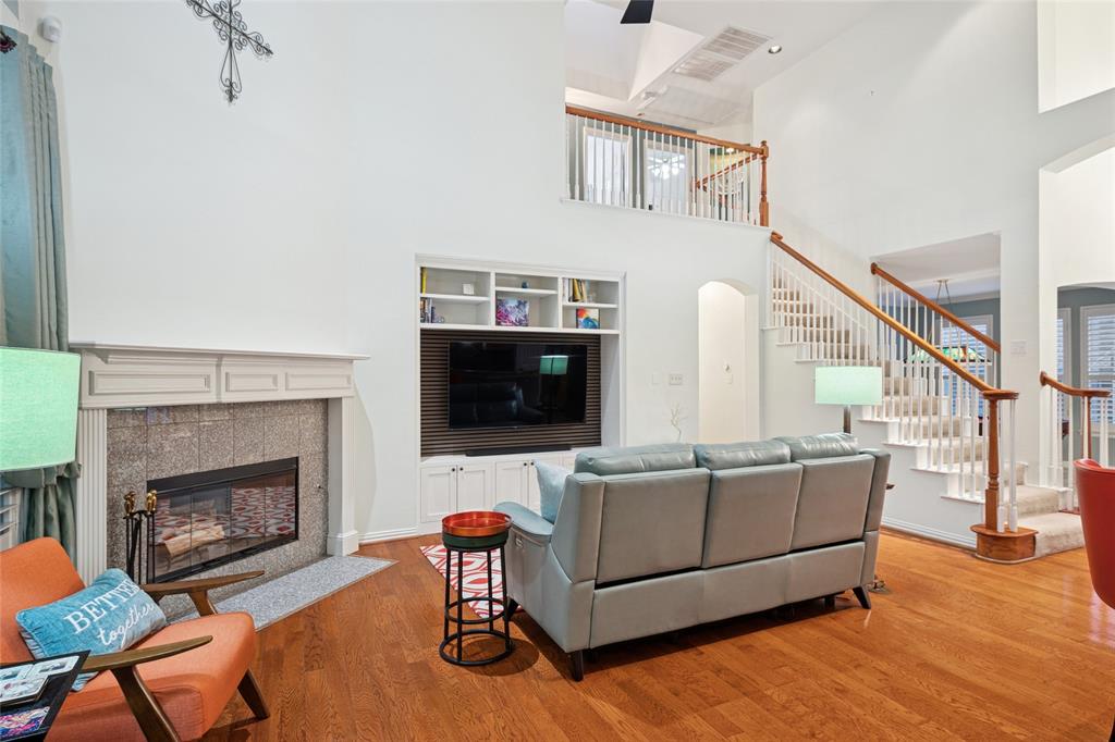 125 Bricknell Lane Coppell, TX 75019 - Photo 11 of 27 a living room with furniture and a fireplace