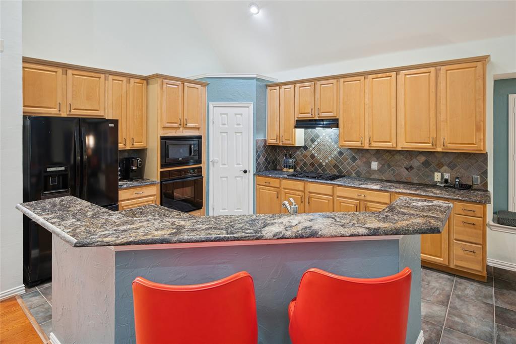 125 Bricknell Lane Coppell, TX 75019 - Photo 13 of 27 a kitchen with stainless steel appliances granite countertop a stove a sink and a microwave
