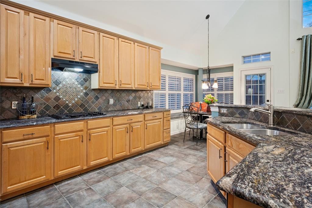 125 Bricknell Lane Coppell, TX 75019 - Photo 15 of 27 a kitchen with stainless steel appliances granite countertop a stove sink and cabinets