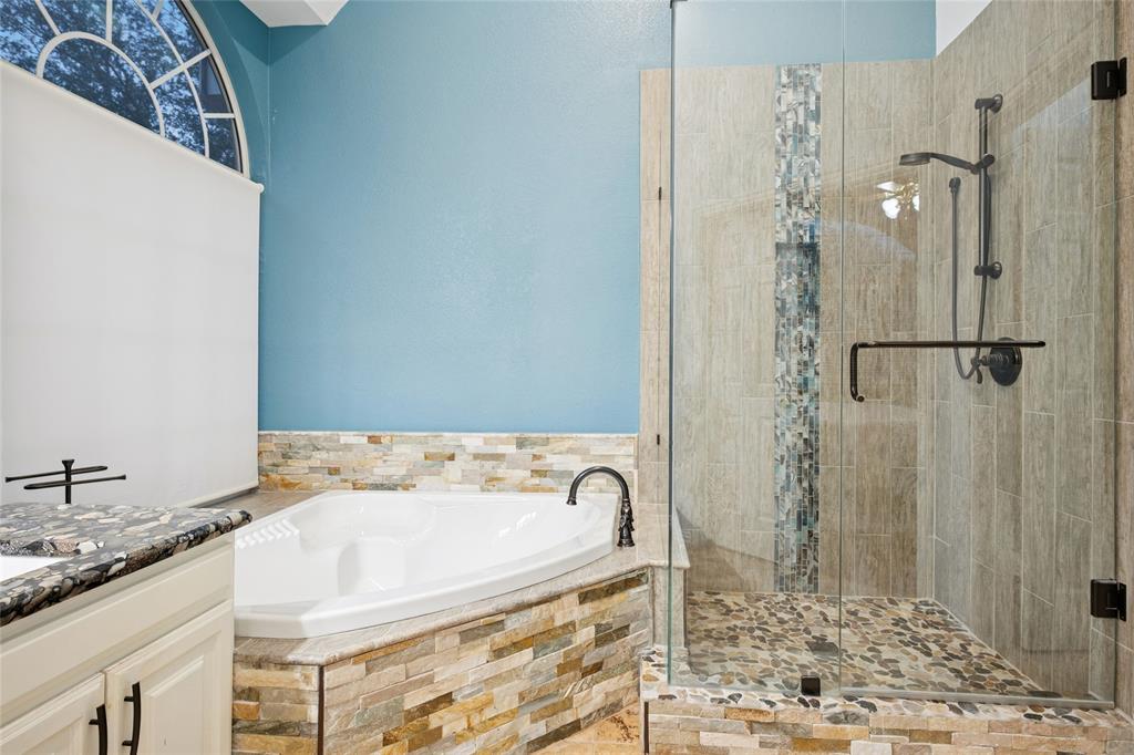 125 Bricknell Lane Coppell, TX 75019 - Photo 20 of 27 a bathroom with a granite countertop sink a mirror and a bathtub