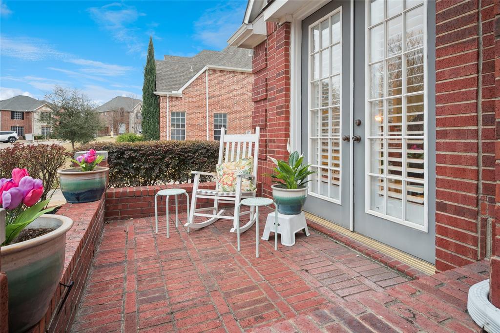 125 Bricknell Lane Coppell, TX 75019 - Photo 2 of 27 a view of a patio with a table and chairs and potted plants
