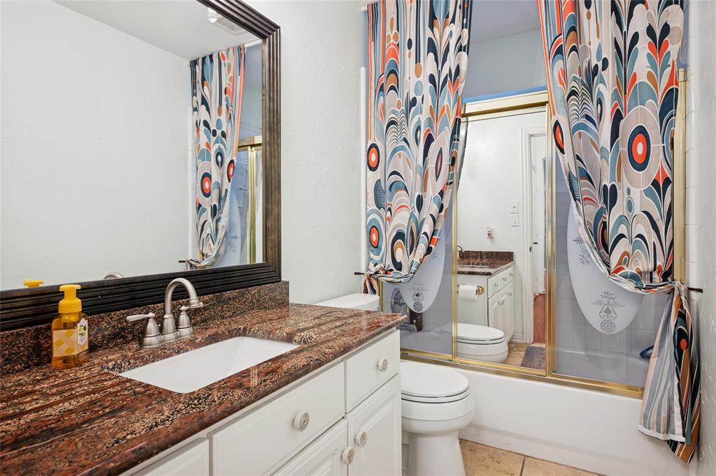 125 Bricknell Lane Coppell, TX 75019 - Photo 23 of 27 a bathroom with a granite countertop sink and a toilet