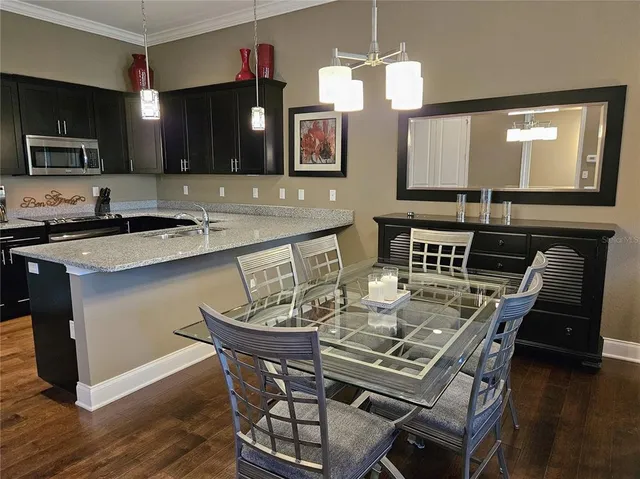 a kitchen with a table chairs sink and microwave