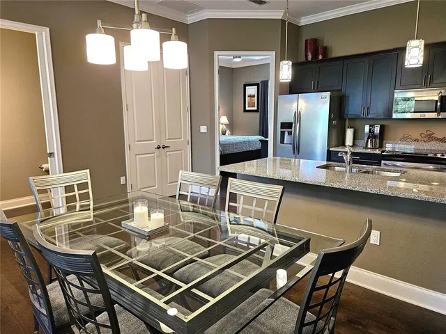 a kitchen with a dining table and chairs