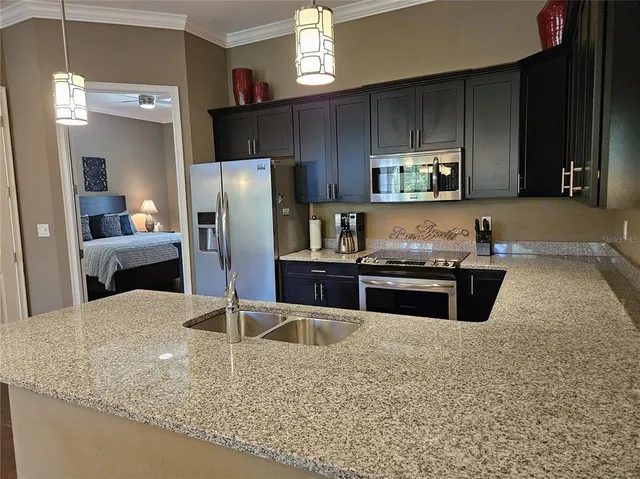 a kitchen with a sink stove and refrigerator