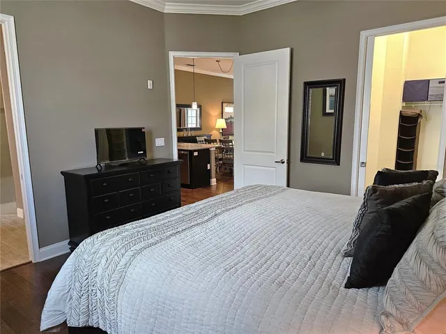 a bedroom with a bed and a television