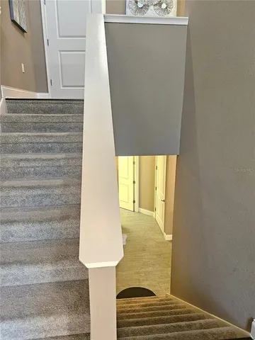 a bedroom with a bed chair and wooden floor