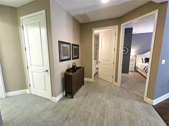 a bedroom with bed and a chandelier