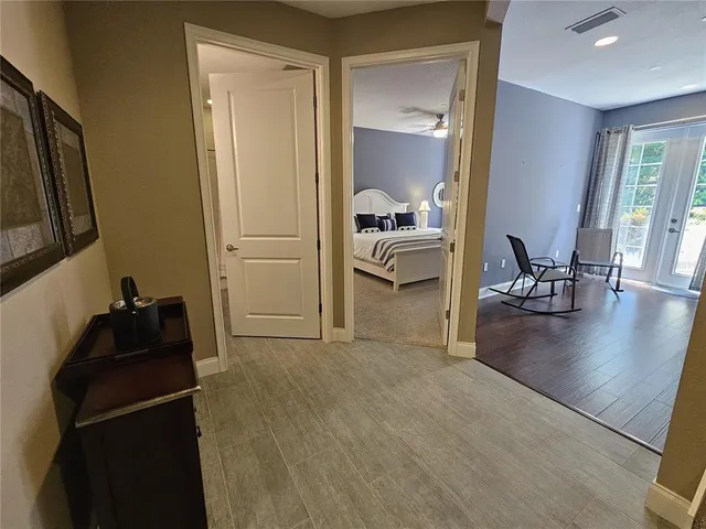 a bed sitting in a bedroom next to a window