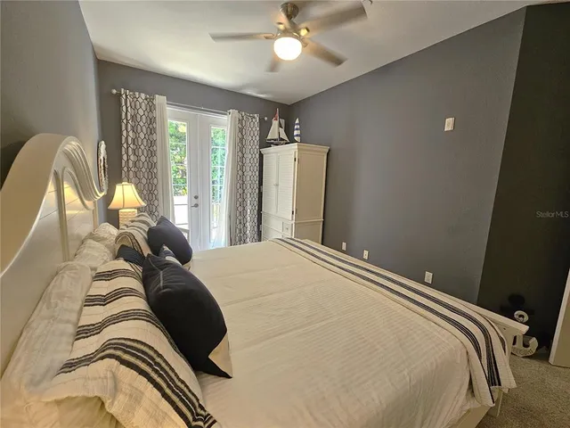 a bedroom with a bed and a mirror