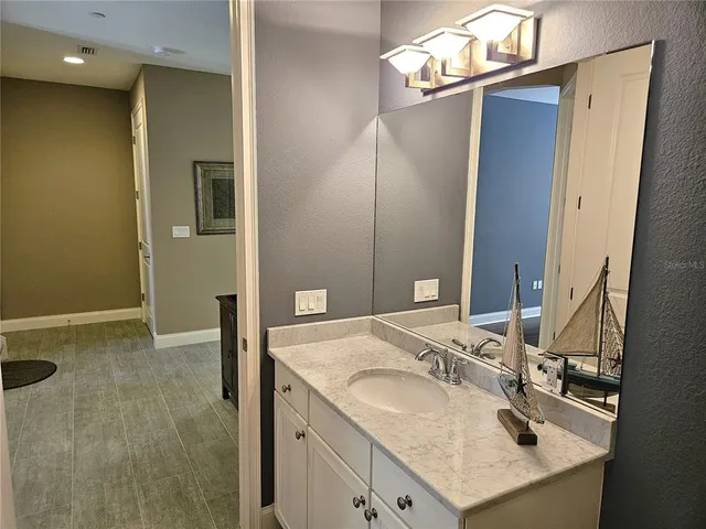 a room with gym equipment and wooden floor