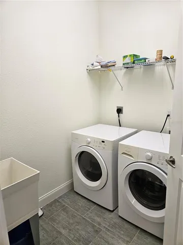 a view of a patio with a table and chairs and potted plants
