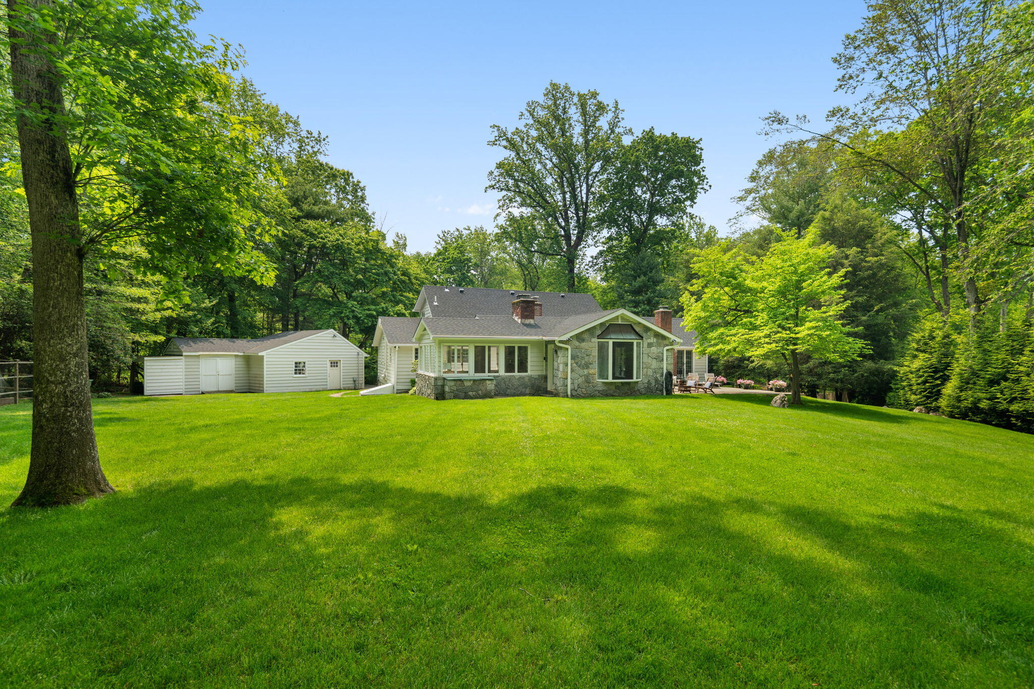 53 Fox Run Road New Canaan, CT 06840 - Photo 32 of 39 a view of a big house with a big yard and large trees