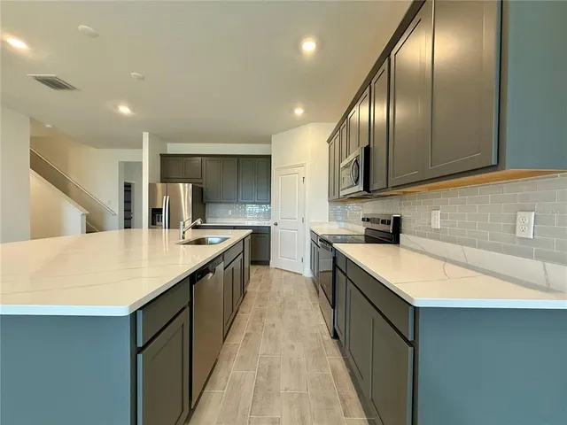 an empty room with a empty space and a sink