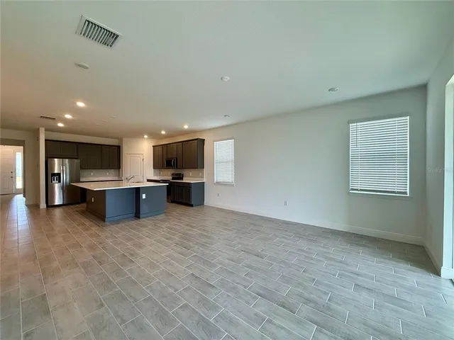 a view of an empty room with glass door