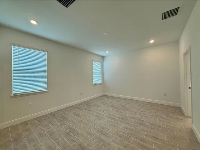 an empty room with closet and wooden floor
