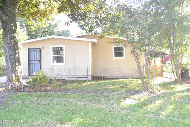 a backyard of a house with large trees