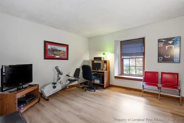 a view of a livingroom with workspace and a window