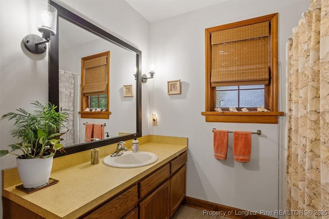 5108 Bridlington Lane Raleigh, NC 27612 - Photo 16 of 19 a bathroom with a granite countertop sink and a mirror