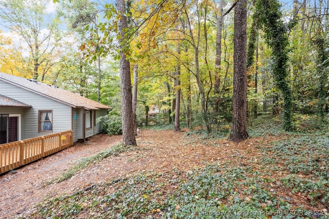 5108 Bridlington Lane Raleigh, NC 27612 - Photo 18 of 19 a view of a house with large trees and wooden fence