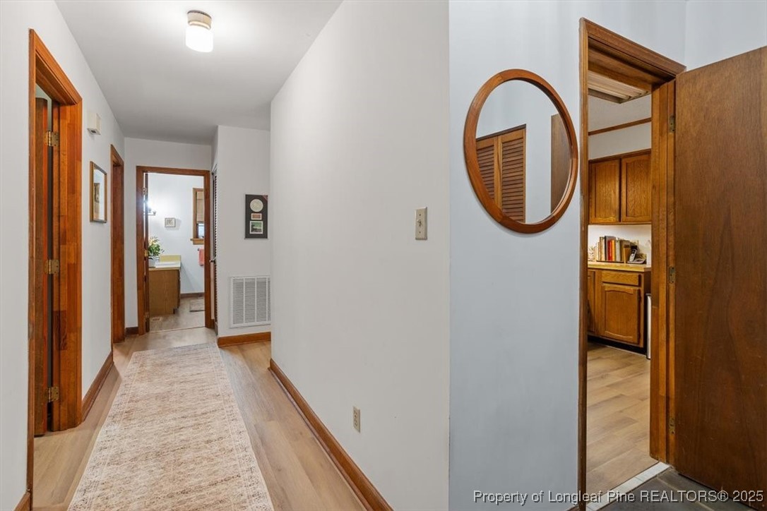 5108 Bridlington Lane Raleigh, NC 27612 - Photo 5 of 19 a view of a bathroom from a corridor