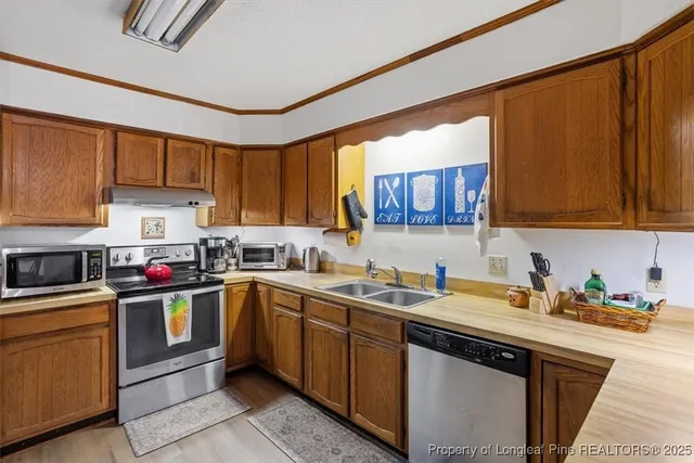 a kitchen with a sink cabinets and stainless steel appliances