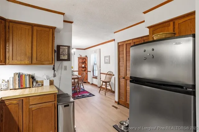 a kitchen with stainless steel appliances granite countertop a refrigerator and a sink