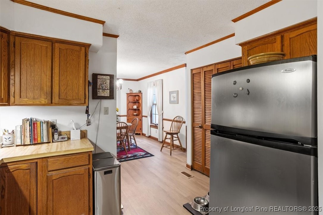 5108 Bridlington Lane Raleigh, NC 27612 - Photo 8 of 19 a kitchen with stainless steel appliances granite countertop a refrigerator and a sink