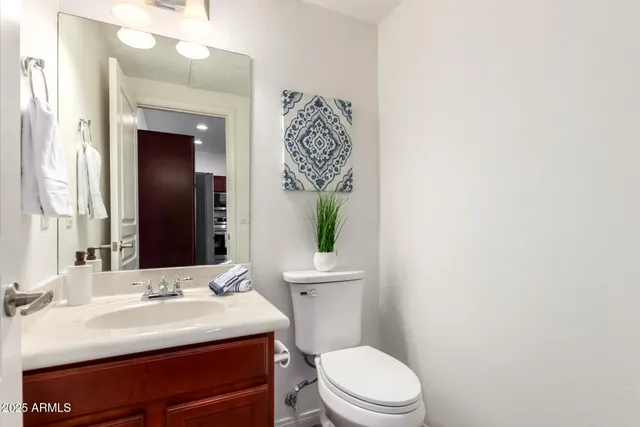a bathroom with a sink a toilet and mirror