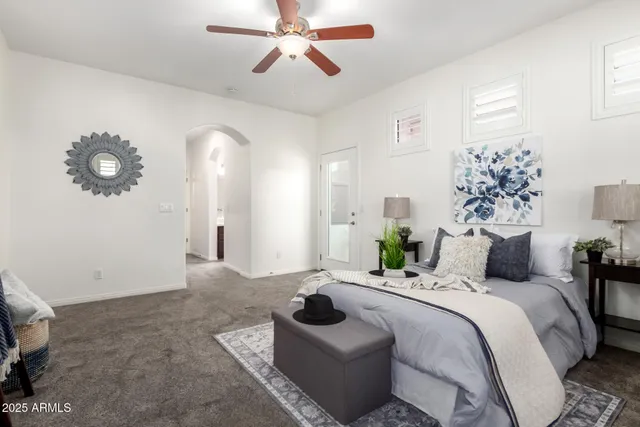 a bedroom with a bed and ceiling fan