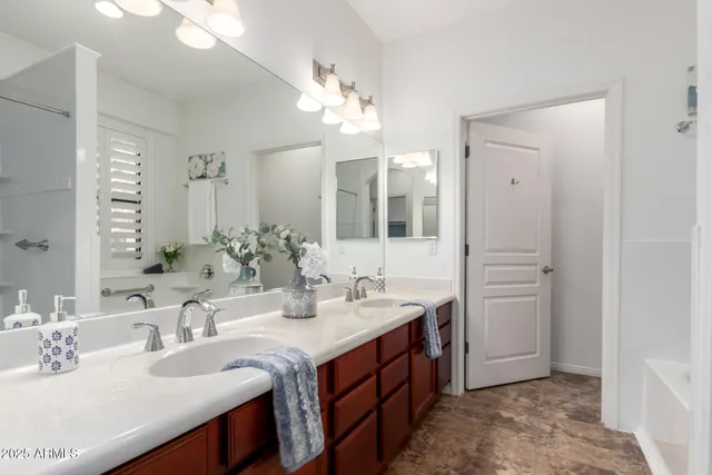 a bathroom with a double vanity sink mirror and