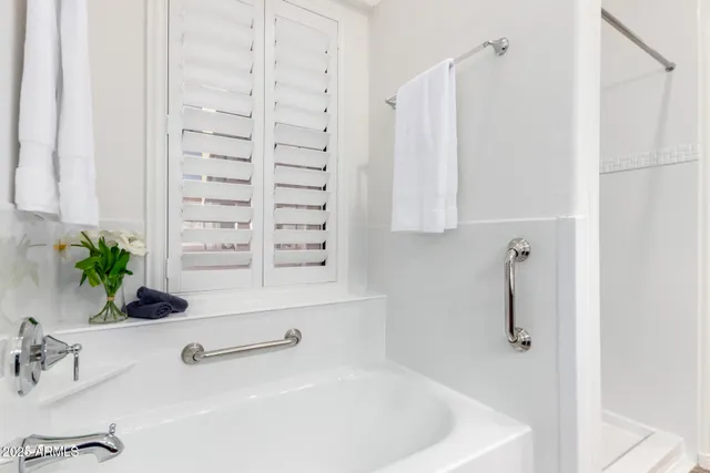 a bathroom with bathtub a shower and a sink