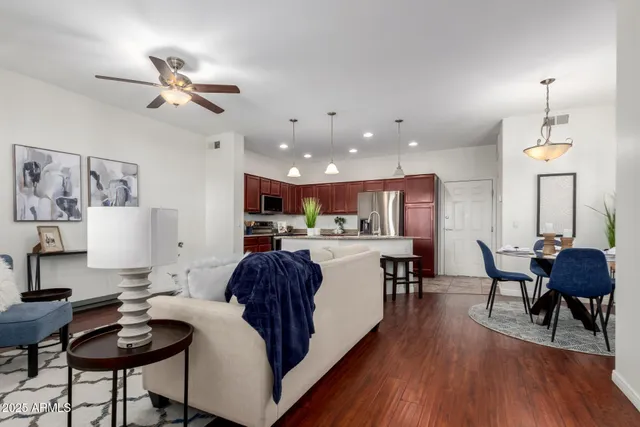 a living room with furniture and kitchen view