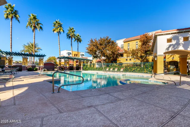 a view of a patio with a table and chairs under an umbrella