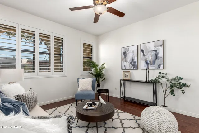 a living room with furniture and a potted plant
