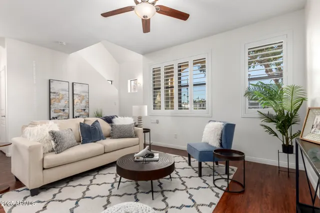a living room with furniture and a potted plant