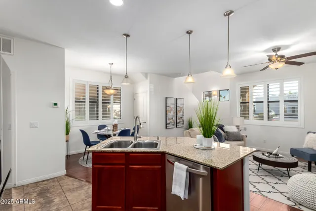 a bathroom with a granite countertop sink and a large mirror
